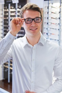 Man Trying On New Glasses At Opticians