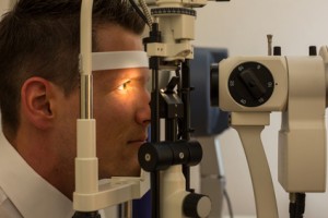 Patient at slit lamp of optician or optometrist